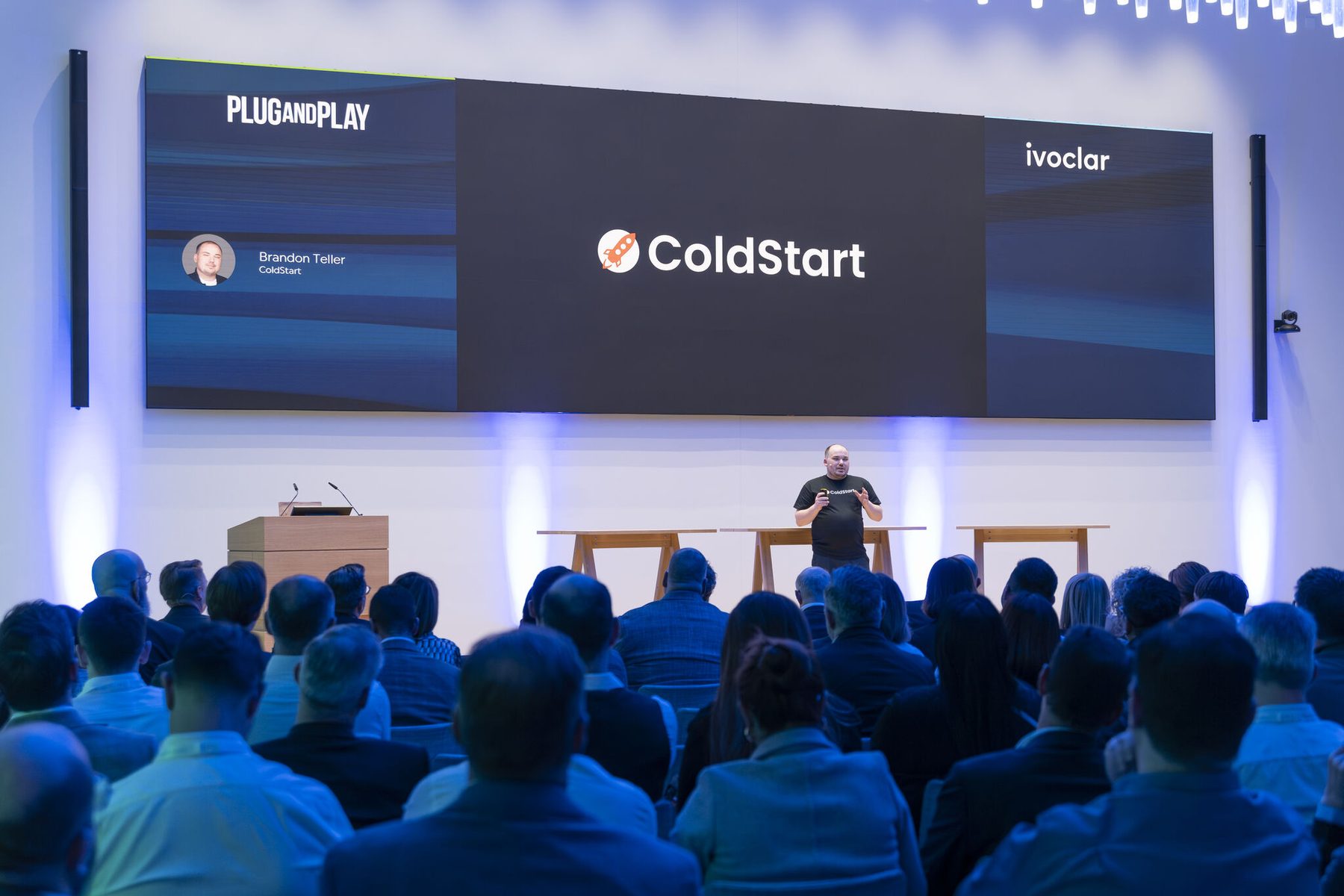 Brandon Teller presenting ColdStart on stage after winning the Plug and Play Innovation Challenge